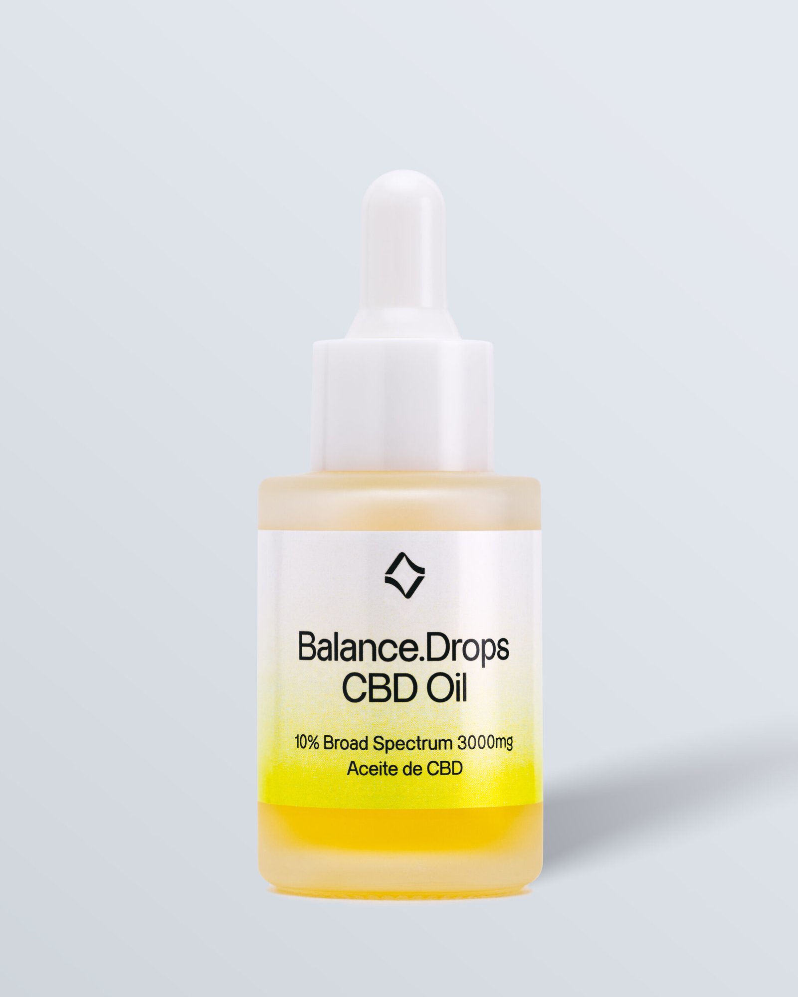 Imagen frontal de un frasco de vidrio con etiqueta amarilla, que muestra 'Balance Drops Oil' con 3000 mg de espectro completo, diseñado para el equilibrio.